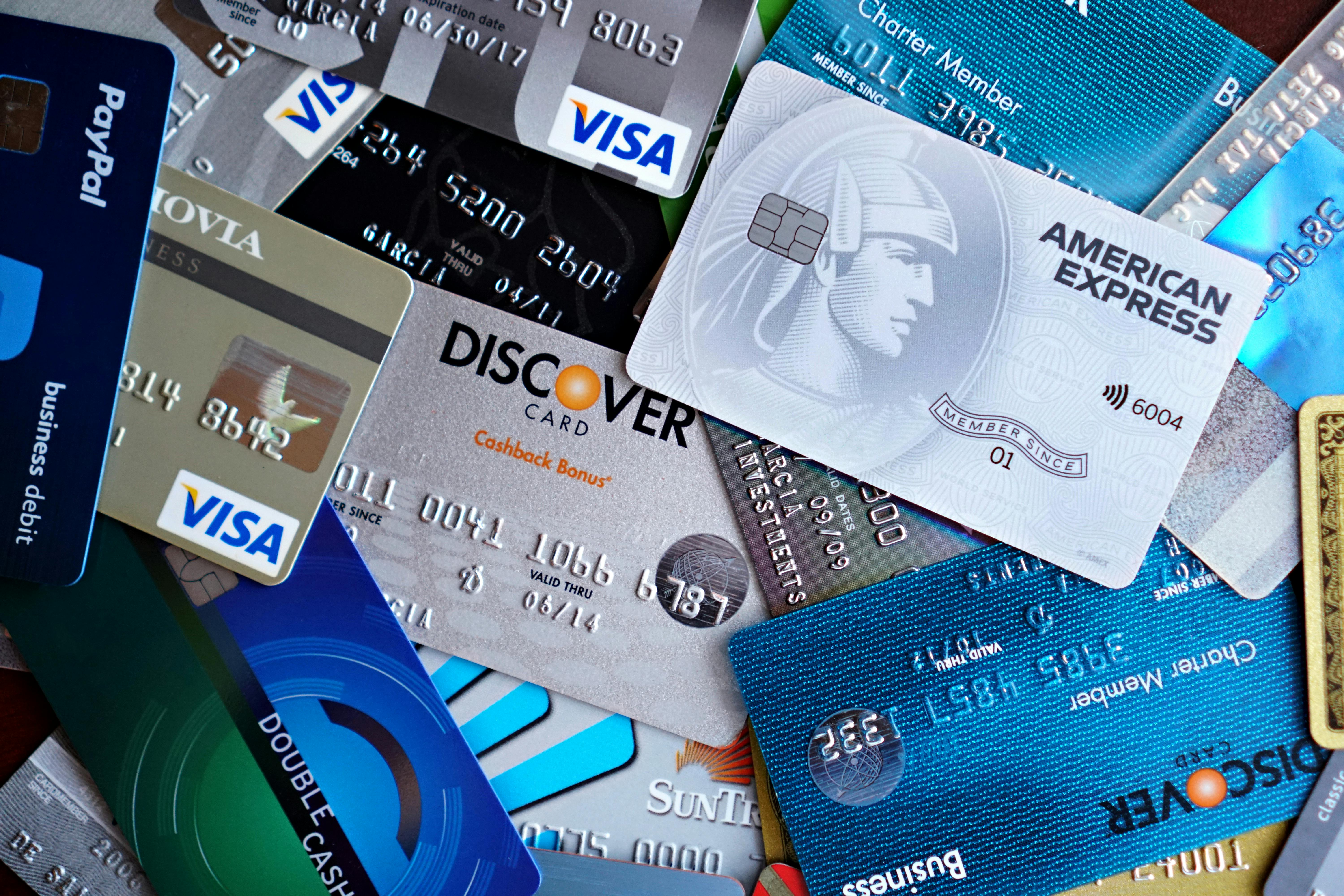 Close-up image of various credit cards including Visa, Mastercard, and American Express.